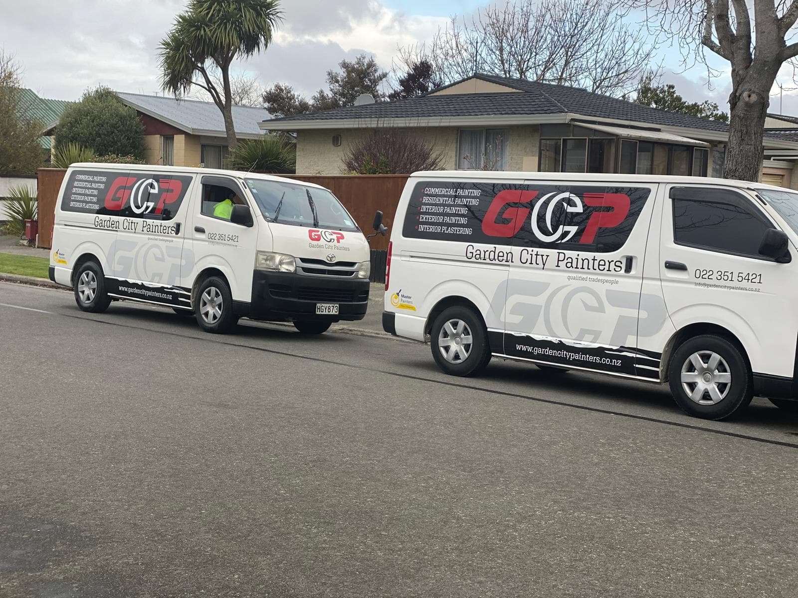 Garden City Painters two branded vans on residential job site Christchurch